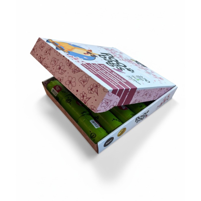 Caja blanca con un perro en la portada y un arbol de cerezo con el logo "poo bags" en el centro de la misma.