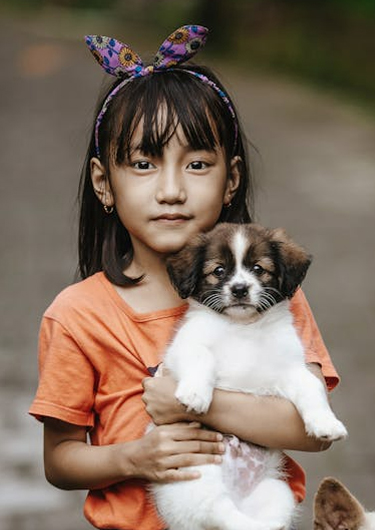 Little girl holding a puppy